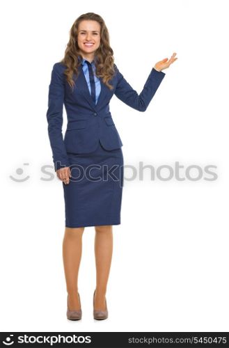 Full length portrait of smiling business woman showing something