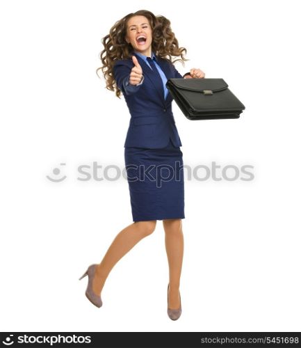 Full length portrait of smiling business woman with briefcase jumping and showing thumbs up