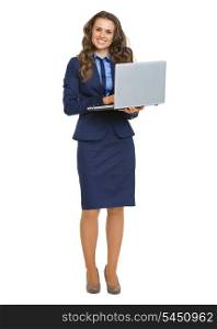 Full length portrait of smiling business woman with laptop
