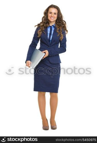 Full length portrait of smiling business woman with laptop
