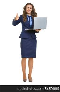 Full length portrait of smiling business woman with laptop showing thumbs up