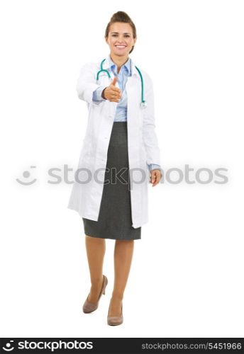 Full length portrait of smiling doctor woman stretching hand for handshake