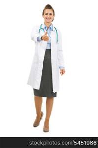 Full length portrait of smiling doctor woman stretching hand for handshake