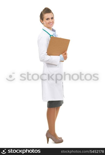 Full length portrait of smiling doctor woman with clipboard