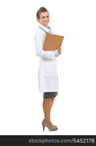 Full length portrait of smiling doctor woman with clipboard