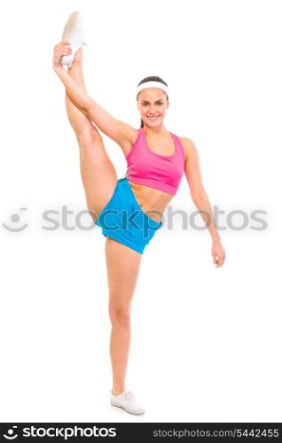 Full length portrait of smiling fit female standing in gym split isolated on white&#xA;