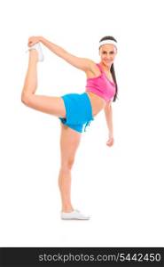 Full length portrait of smiling fitness girl doing stretching exercise isolated on white&#xA;