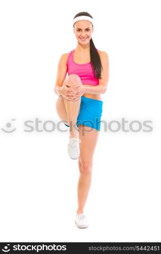 Full length portrait of smiling fitness woman doing stretching exercise isolated on white&#xA;