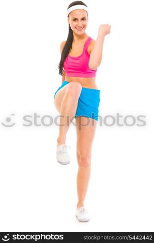 Full length portrait of smiling girl in sportswear doing fitness exercise&#xA;