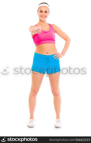 Full length portrait of smiling girl in sportswear showing thumbs up&#xA;