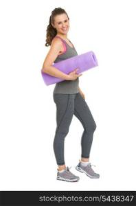 Full length portrait of smiling healthy young woman with fitness mat