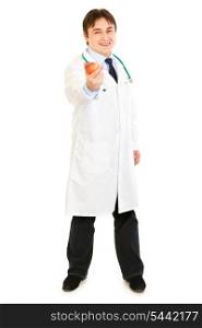Full length portrait of smiling medical doctor holding apple in hand isolated on white&#xA;