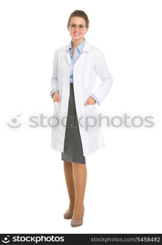 Full length portrait of smiling ophthalmologist doctor woman in eyeglasses