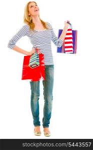 Full length portrait of smiling teen girl with shopping bags looking up&#xA;