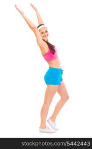 Full length portrait of smiling woman in sportswear making exercise&#xA;