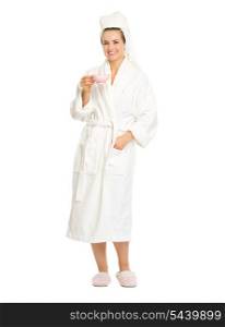 Full length portrait of smiling young woman in bathrobe with cup of coffee