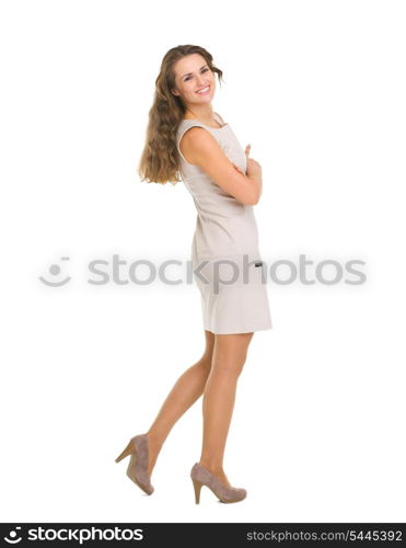 Full length portrait of smiling young woman in dress