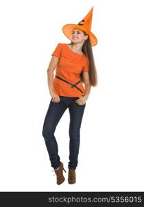 Full length portrait of smiling young woman in Halloween hat