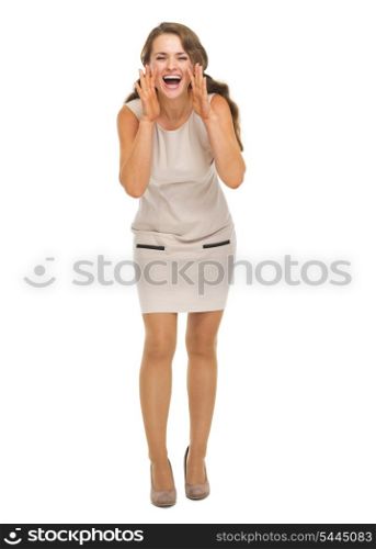 Full length portrait of smiling young woman shouting through megaphone shaped hands