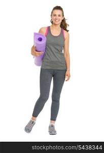 Full length portrait of smiling young woman with fitness mat