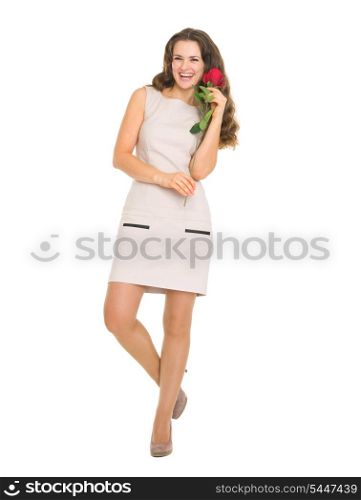 Full length portrait of smiling young woman with red rose