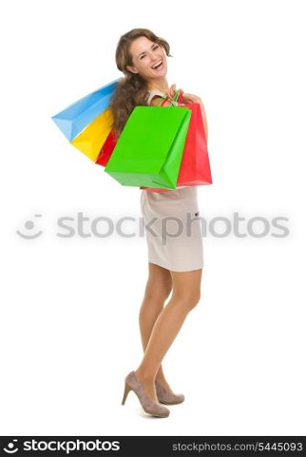 Full length portrait of smiling young woman with shopping bags