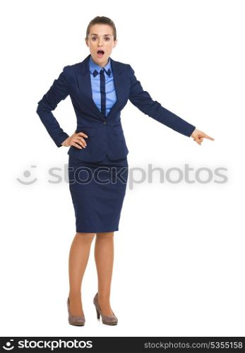 Full length portrait of surprised business woman pointing on copy space