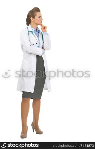 Full length portrait of thoughtful doctor woman looking on copy space