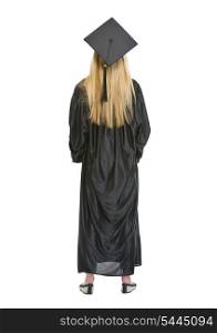 Full length portrait of woman in graduation gown . rear view