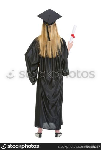 Full length portrait of woman in graduation gown showing diploma . rear view