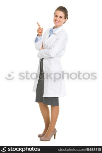 Full length portrait of woman in white robe pointing on copy space