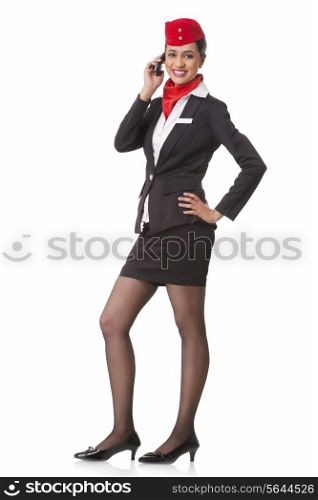 Full length portrait of young airhostess on call isolated over white background