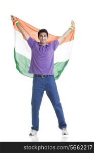 Full length portrait of young man in casuals holding Indian flag over white background