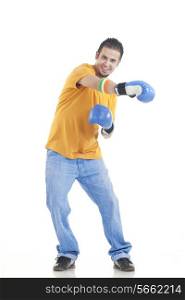 Full length portrait of young man in casuals wearing boxing gloves over white background