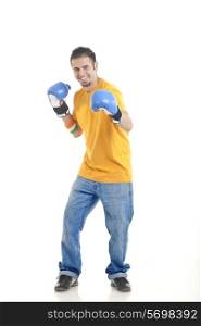 Full length portrait of young man wearing boxing gloves over white background
