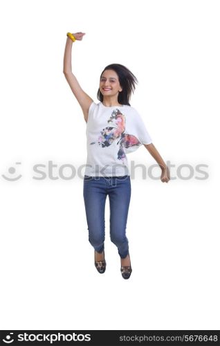 Full length portrait of young woman cheering and jumping over white background