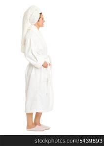 Full length portrait of young woman in bathrobe looking on copy space