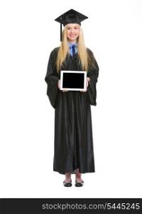 Full length portrait of young woman in graduation gown showing tablet pc