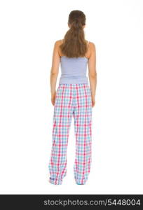 Full length portrait of young woman in pajamass. Rear view