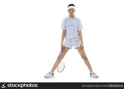 Full length portrait of young woman in sports wear holding badminton racket isolated over white background