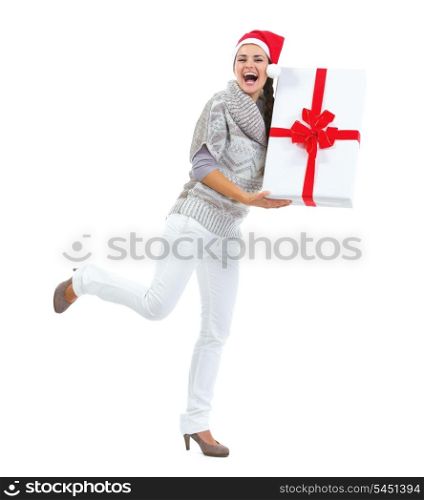 Full length portrait of young woman in sweater and christmas hat with big christmas present box