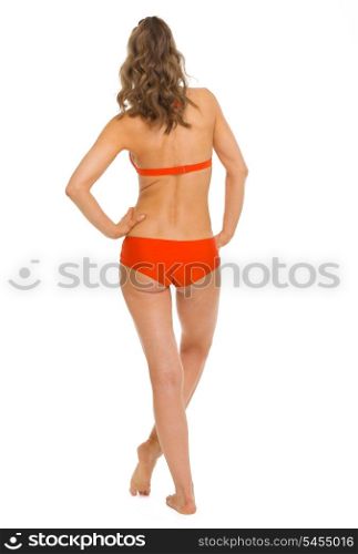 Full length portrait of young woman in swimsuit . rear view