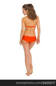 Full length portrait of young woman in swimsuit . rear view