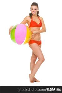 Full length portrait of young woman in swimsuit with beach ball