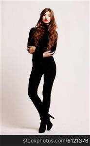 Full-length portrait young elegant woman in a black turtleneck and black skinny jeans. Fashion studio shot. Fashion model