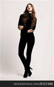 Full-length portrait young elegant woman in a black turtleneck and black skinny jeans. Fashion studio shot. Fashion model