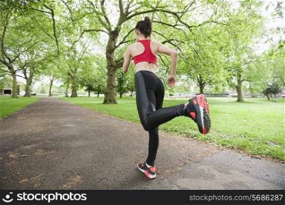 Full length rear view of fit woman jogging in park