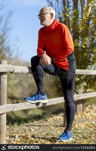 Full length Runner in red sportswear standing