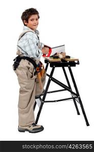 Full length shot of a young boy pretending to be a carpenter