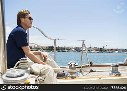Full-length side view of man sitting on yacht